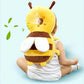 Baby sitting up wearing the bee head protector backpack