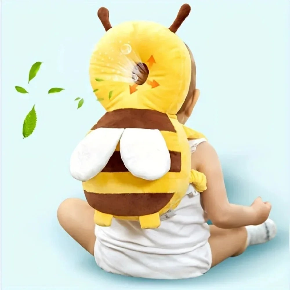 Baby sitting up wearing the bee head protector backpack