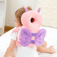 Baby sitting on a bed with the pink butterfly head protector