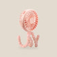 Pink clip on pram fan standing on its bendy legs