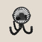 Black clip on pram fan standing on its bendy legs